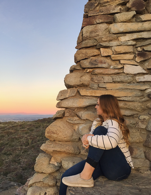 Girl Sitting on a Cliff at Sunset