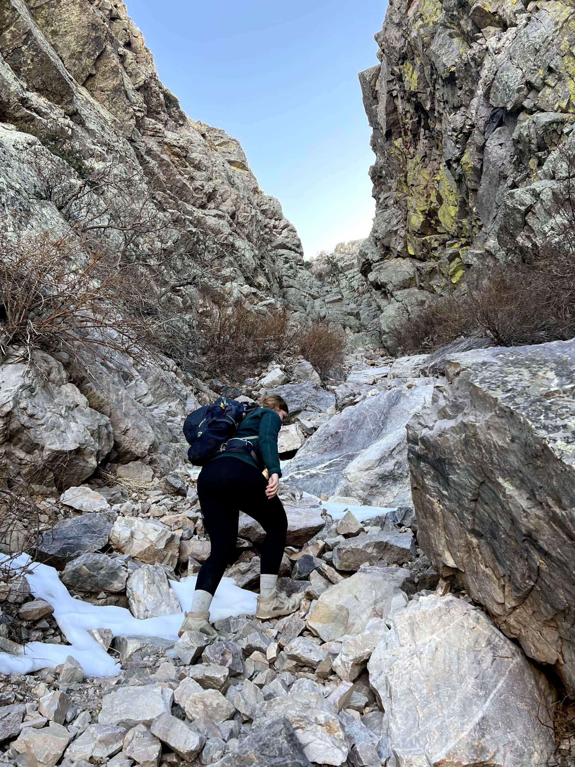 Person Climbing Up a Steep Mountain