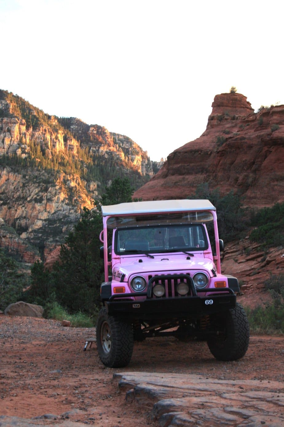Pink Jeep Tour Parked onto a Dirt Road at Sunset