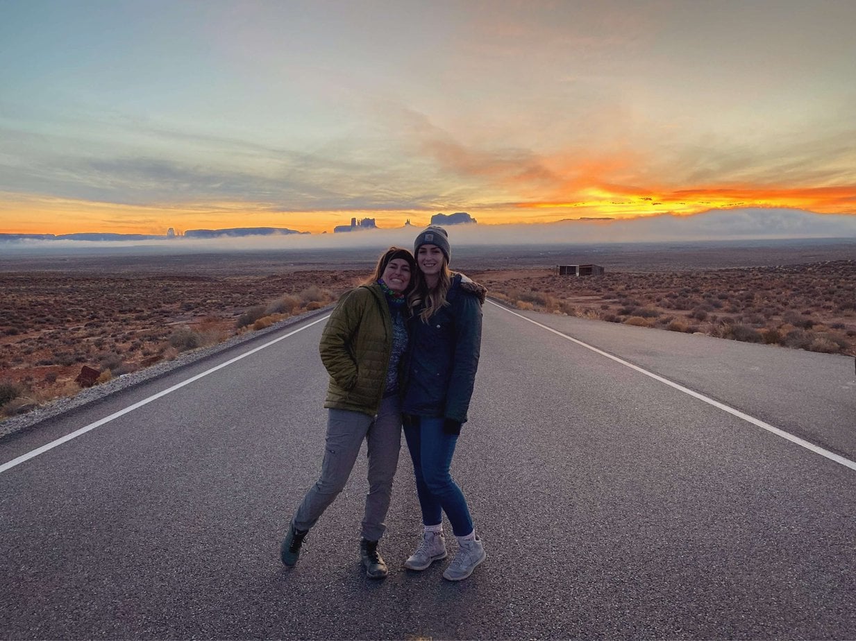 Two Women on the Road at Sunset in the Desert