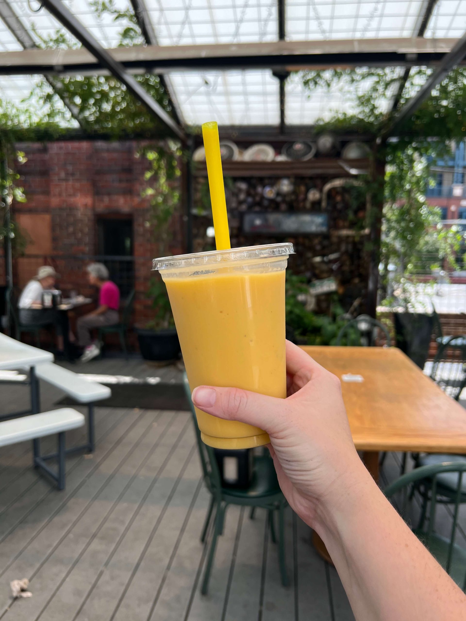 Yellow Smoothie at a Restaurant with Plants