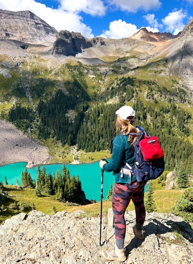 Girl with a Medical Kit Standing Above Blue Lakes