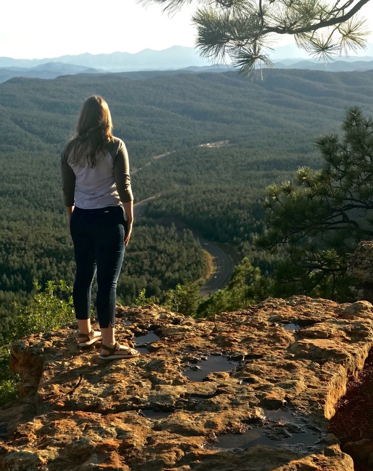 Girl Standing over a Viewpoint in the Forest