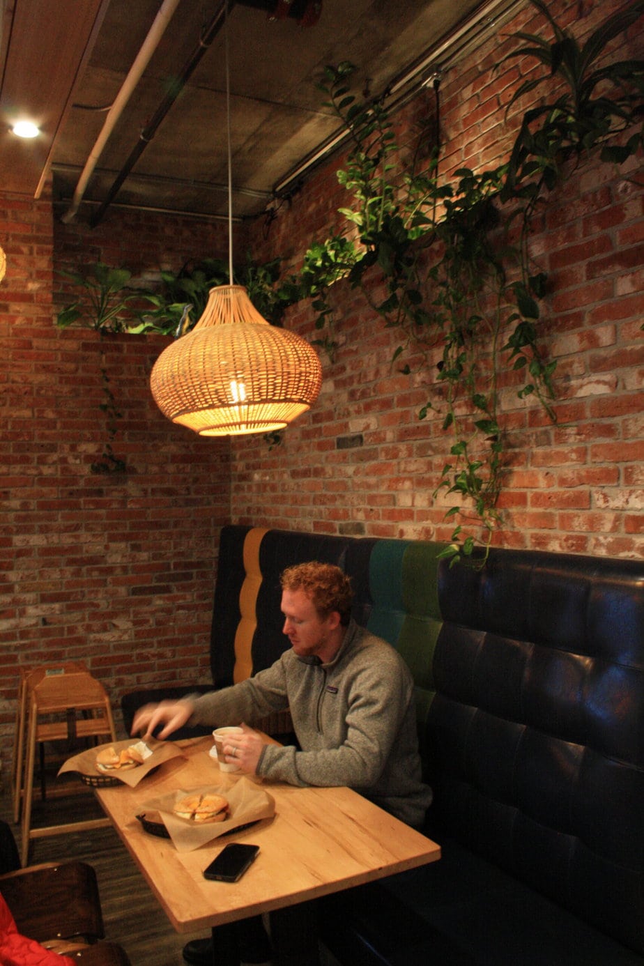 Man Eating with a Chandelier Above Him