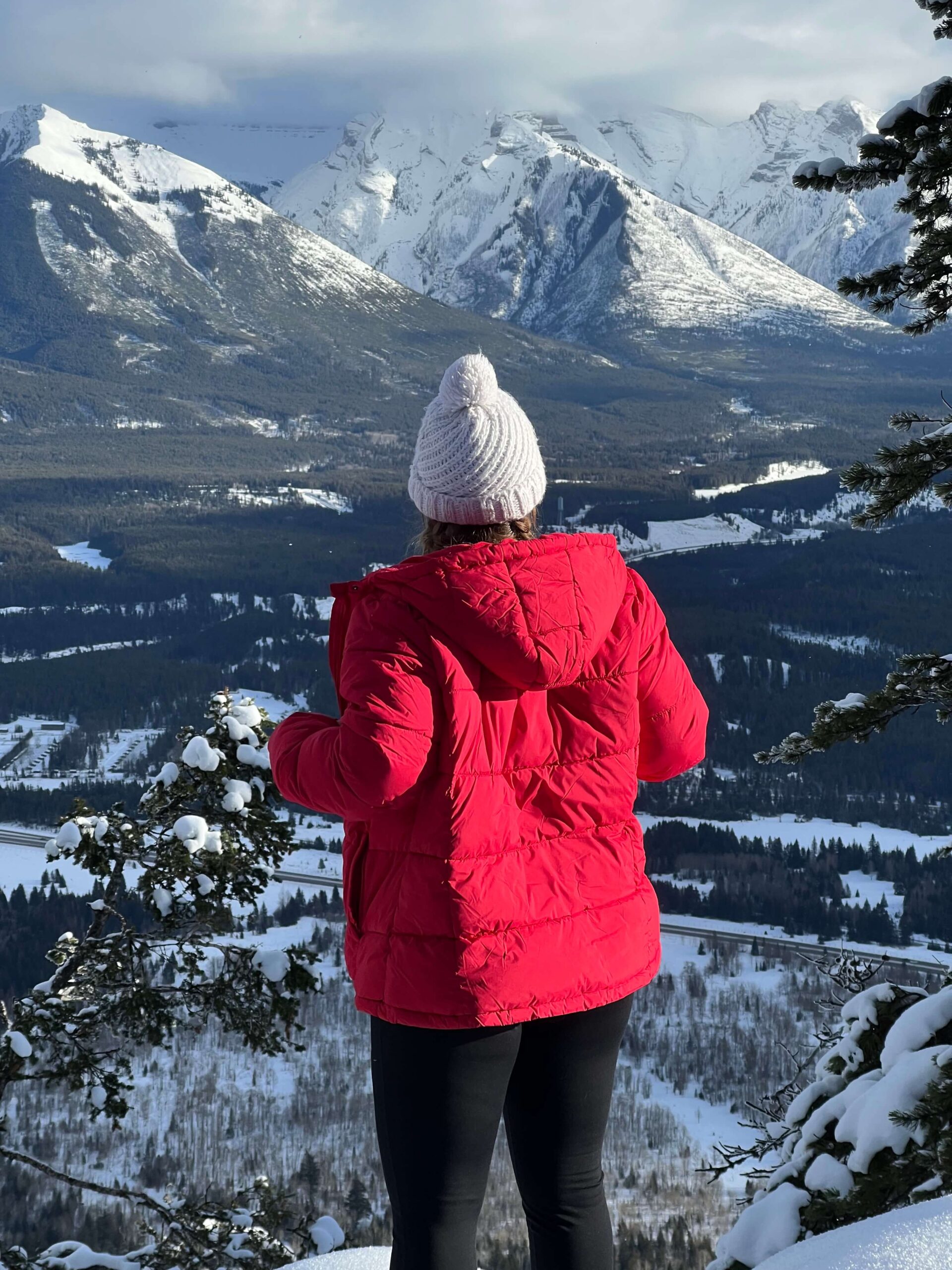 Girl in a Red Jacket and White Hat in the Winter