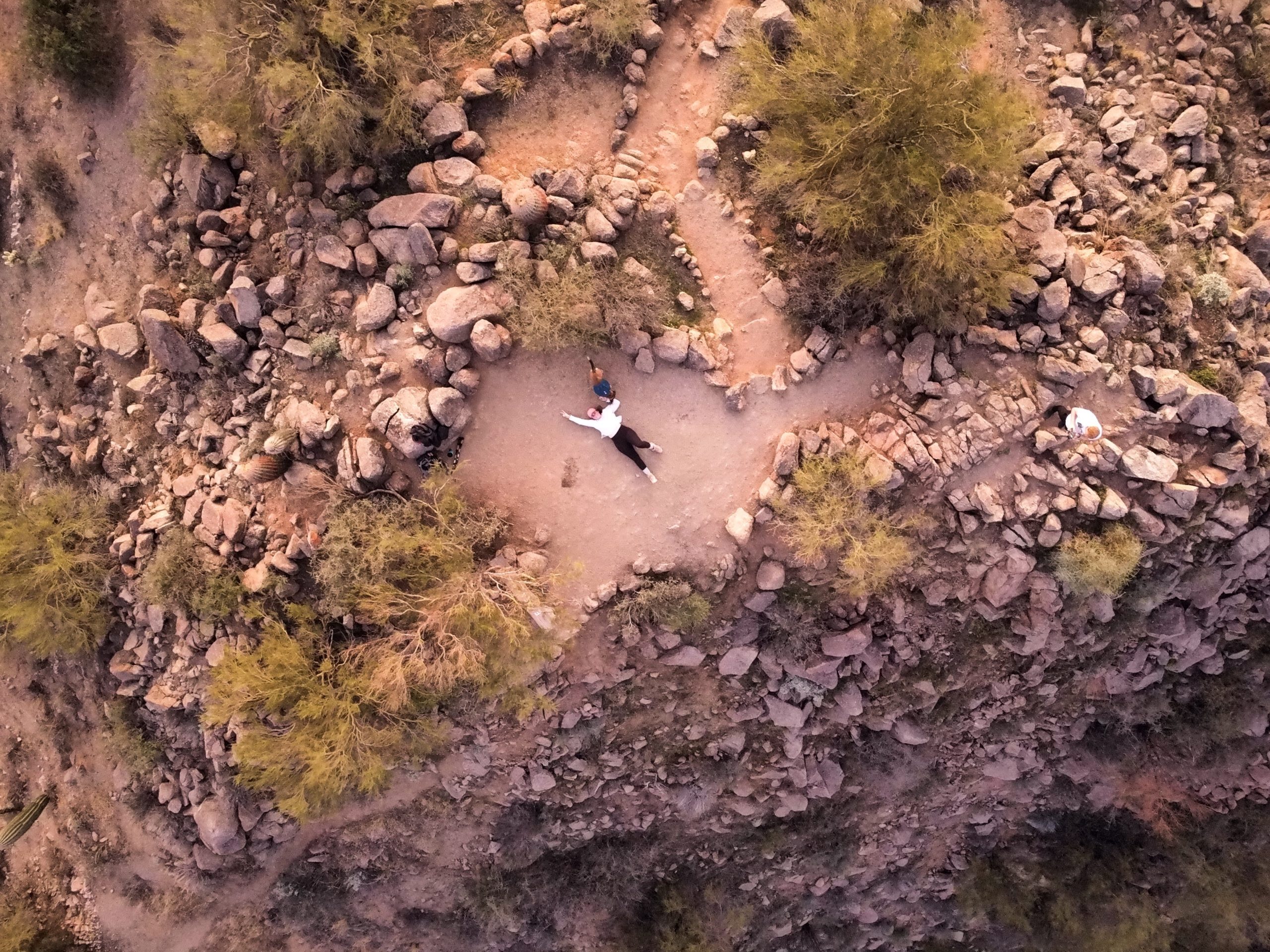 Girl Laying on a Mountain Summit- Top Down Photo