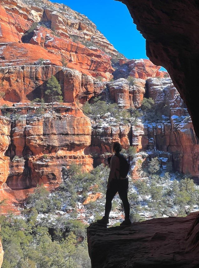 silhouette of girl standing in sedona in the snow