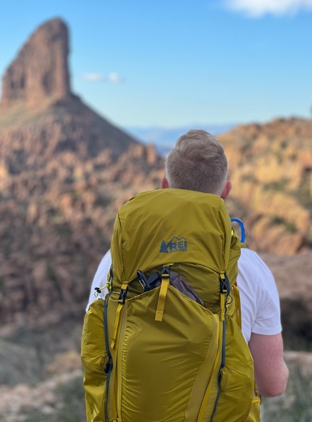 man in yellow backpack in the desert