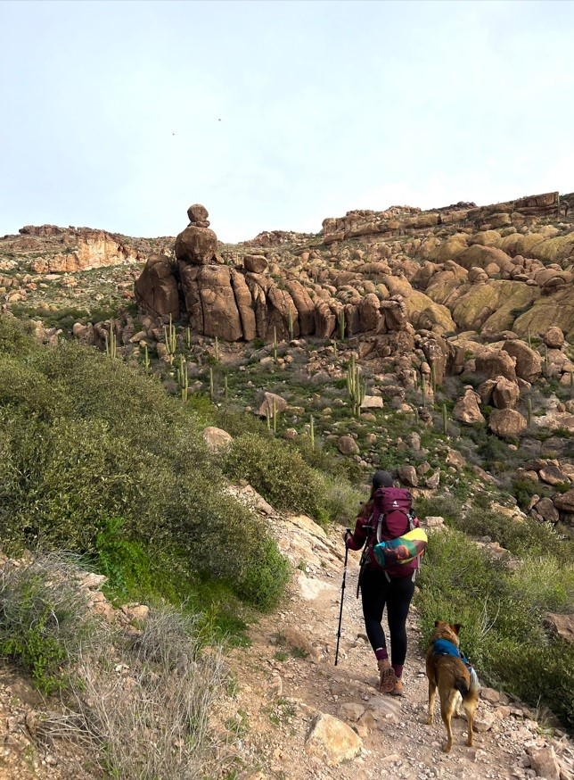 Girl with Hiking Sticks, Black Pants, and a Big Backpack Hiking
