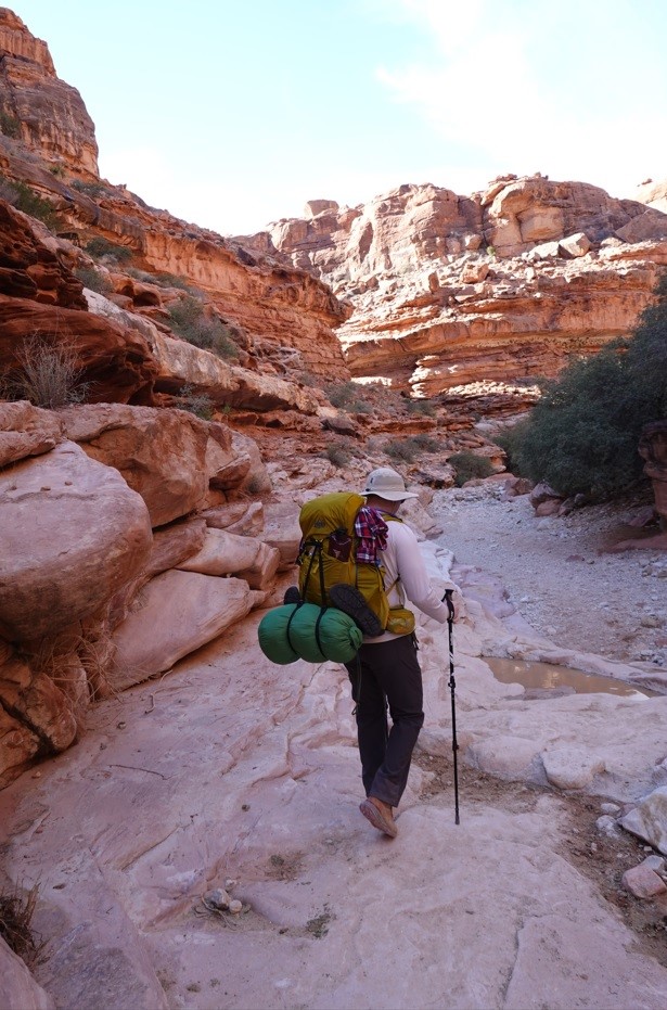 man with backpacking gear hiking in the grand canyon