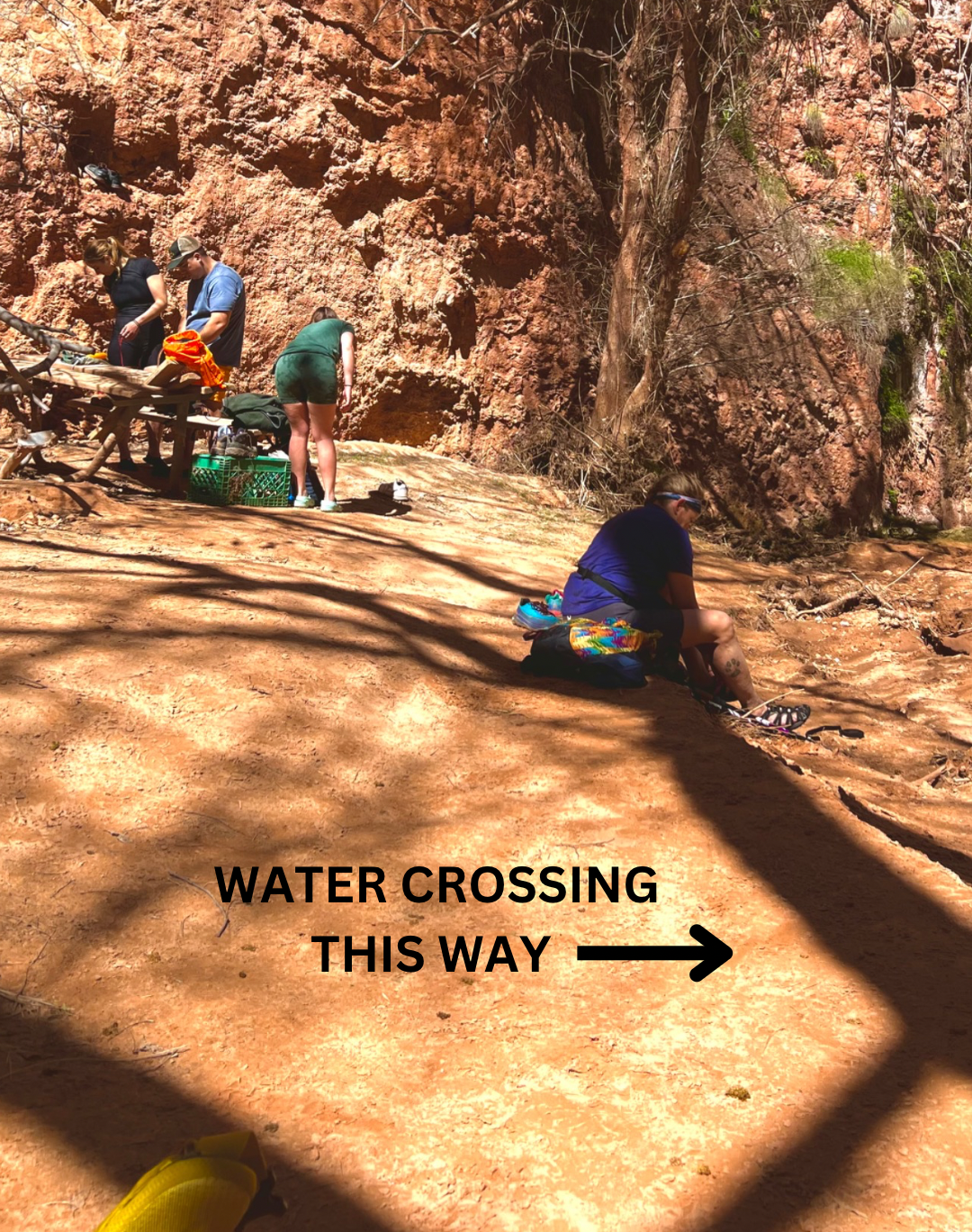 people up against the canyon wall changing clothes