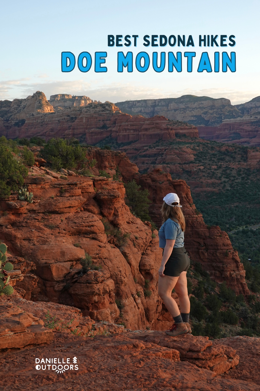 girl standing on a red rock cliff