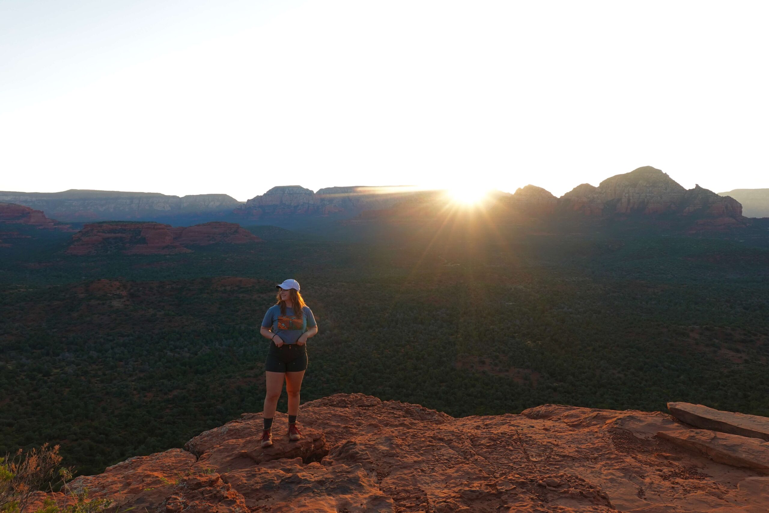 Girl Standing on a Ledge at Sunrise