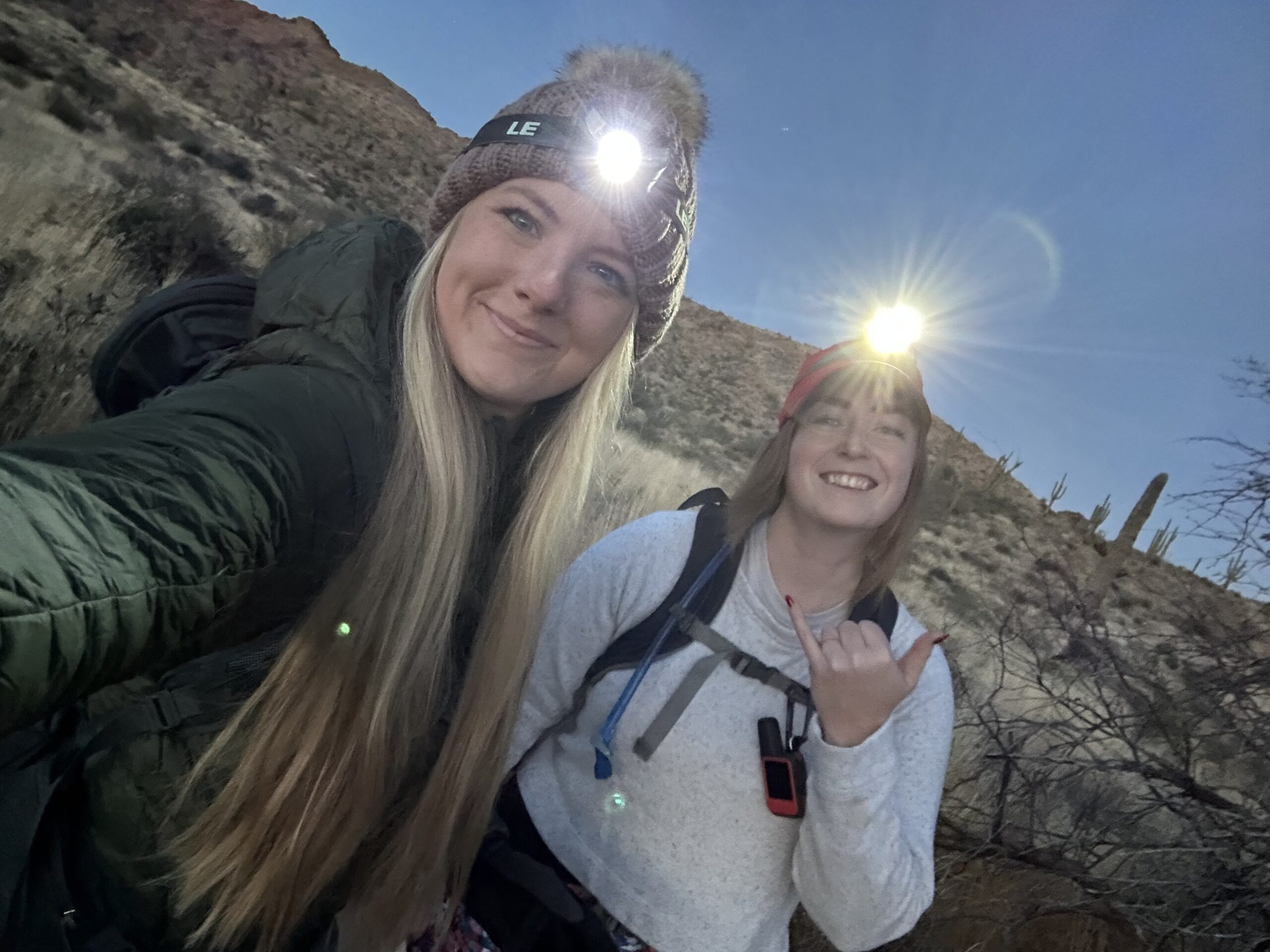 two girls with headlamps in the desert