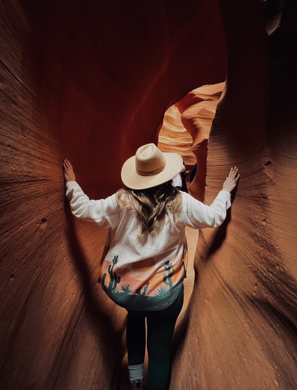 Girl in a Jacket and Wide Hat in an Orange Slot Canyon