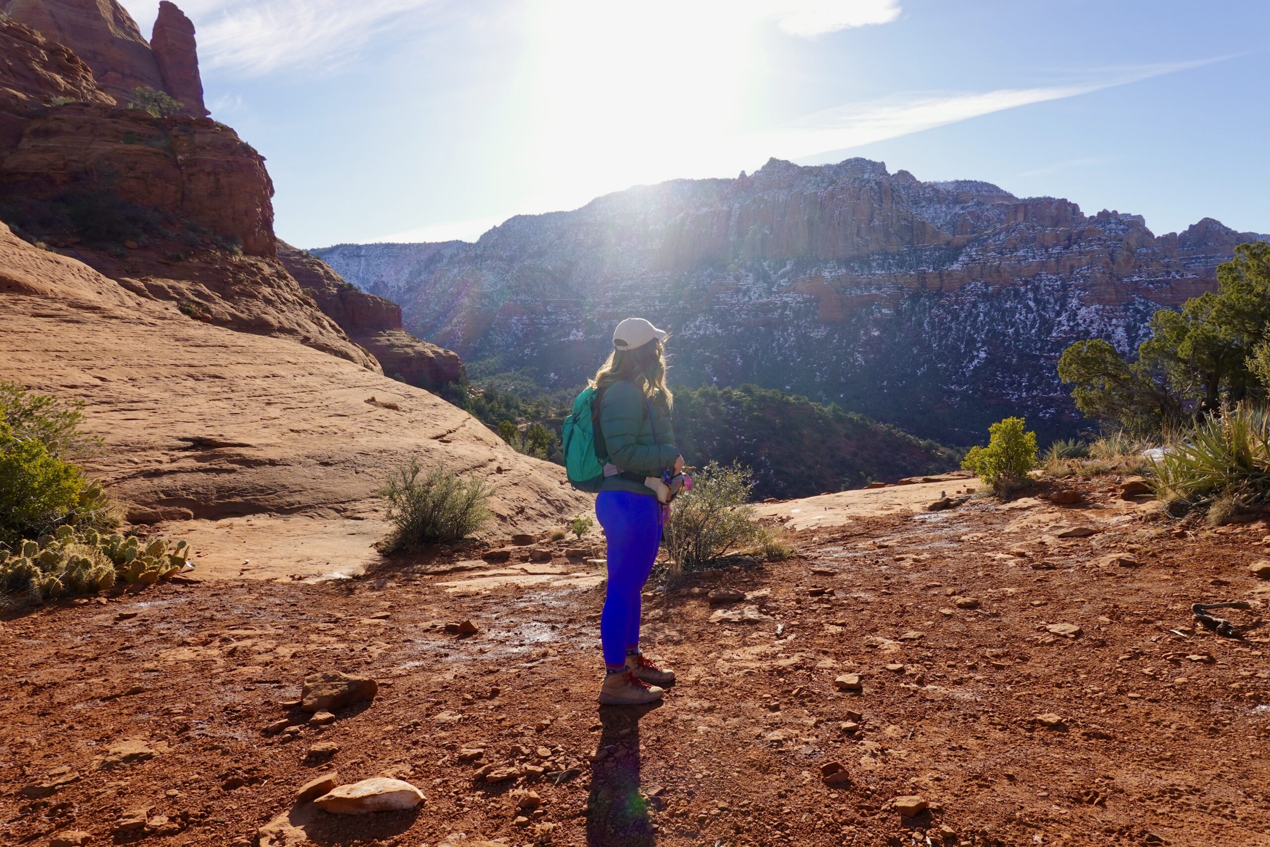 girl in blue standing on a trail in sedona 
