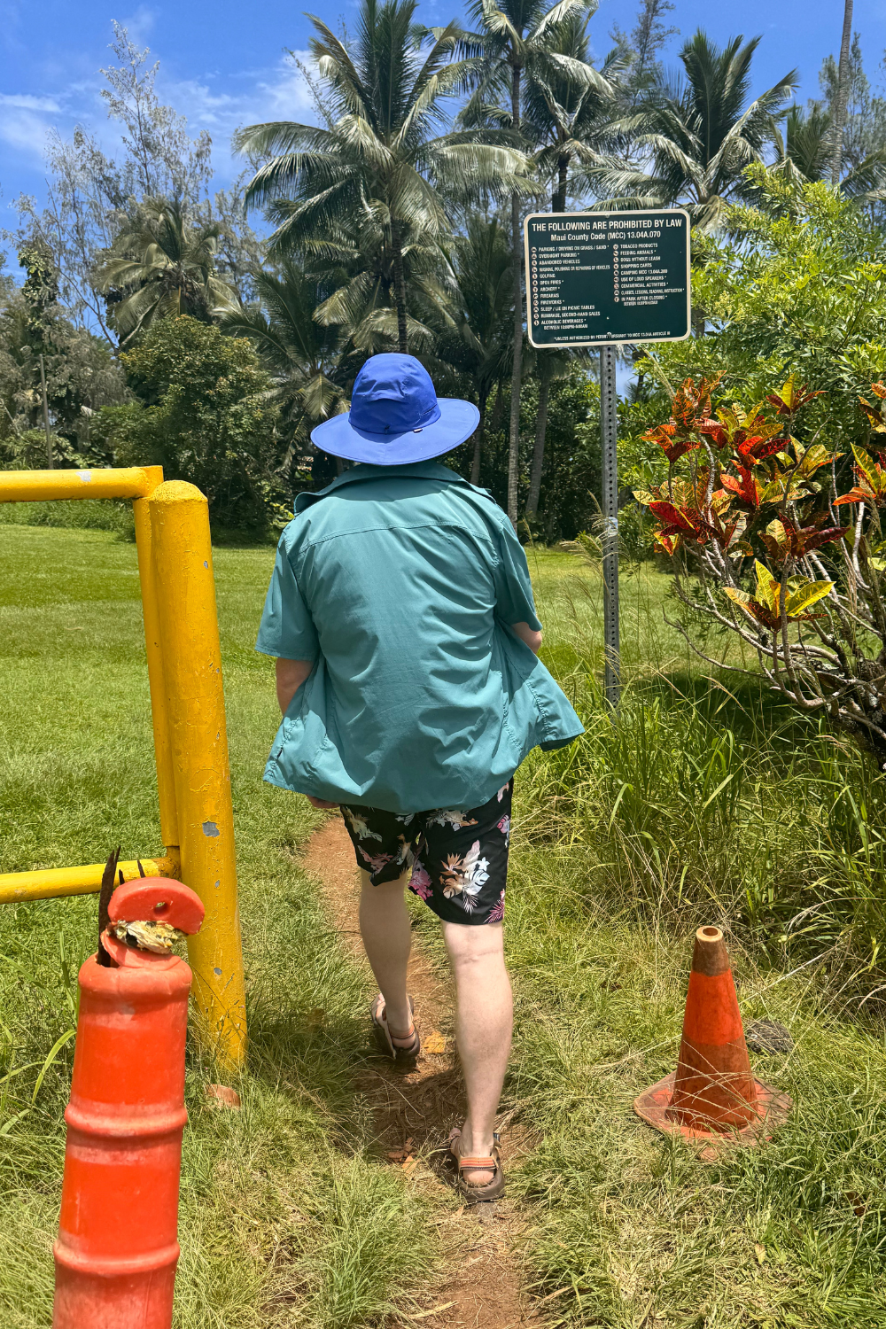 man hiking to red sand beach