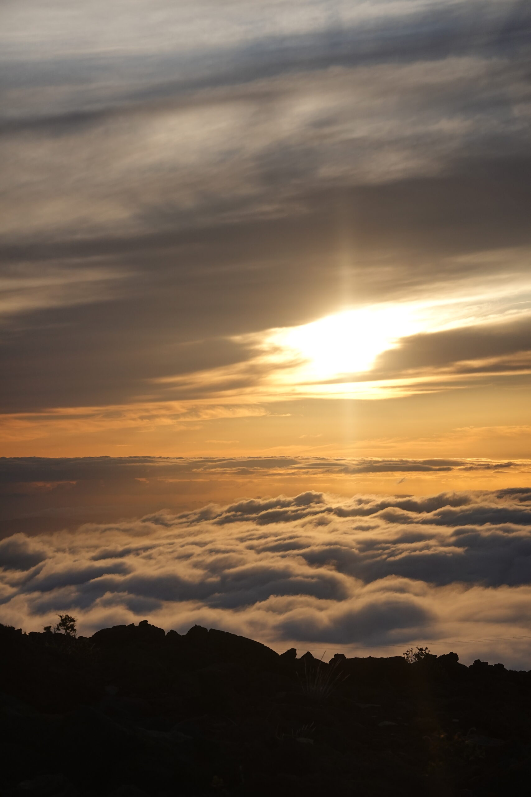 sun above the clouds on a mountain