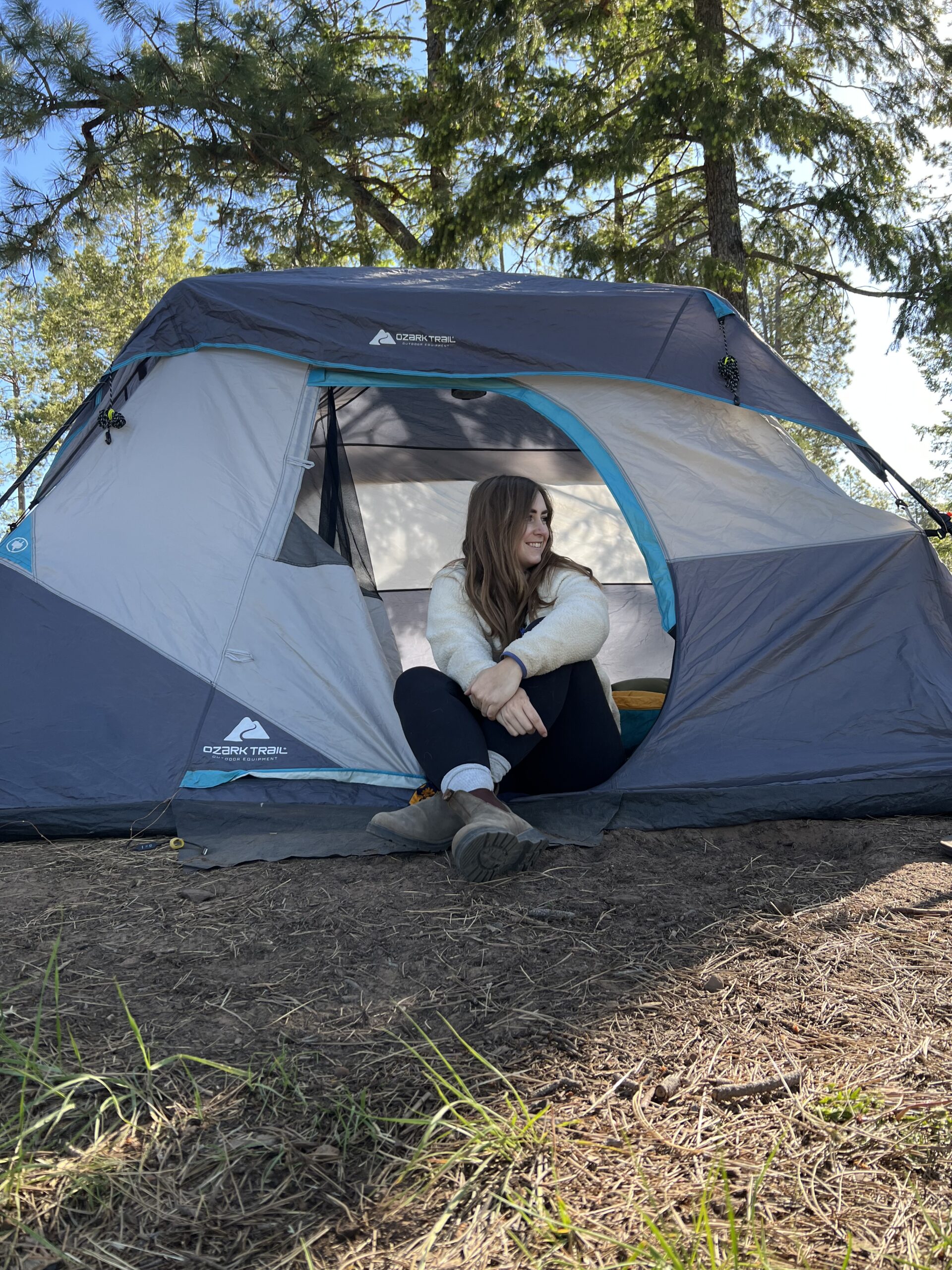 girl sitting in a tent camping