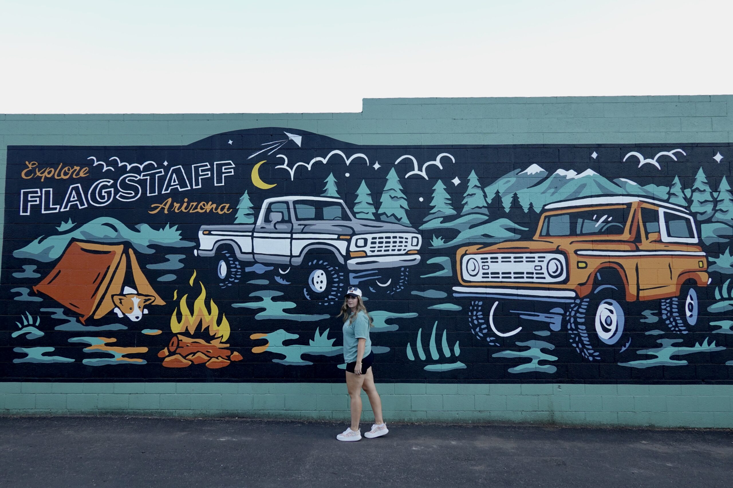 girl in front of a mural reading flagstaff arizona