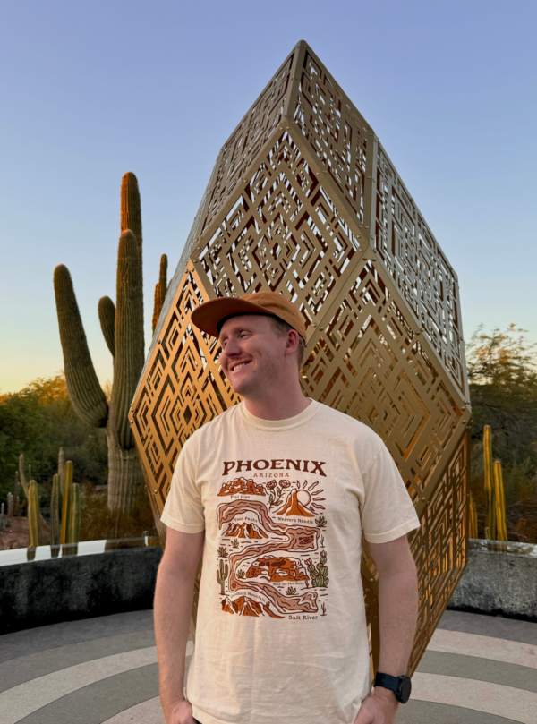 man wearing a beige tshirt saying phoenix arizona