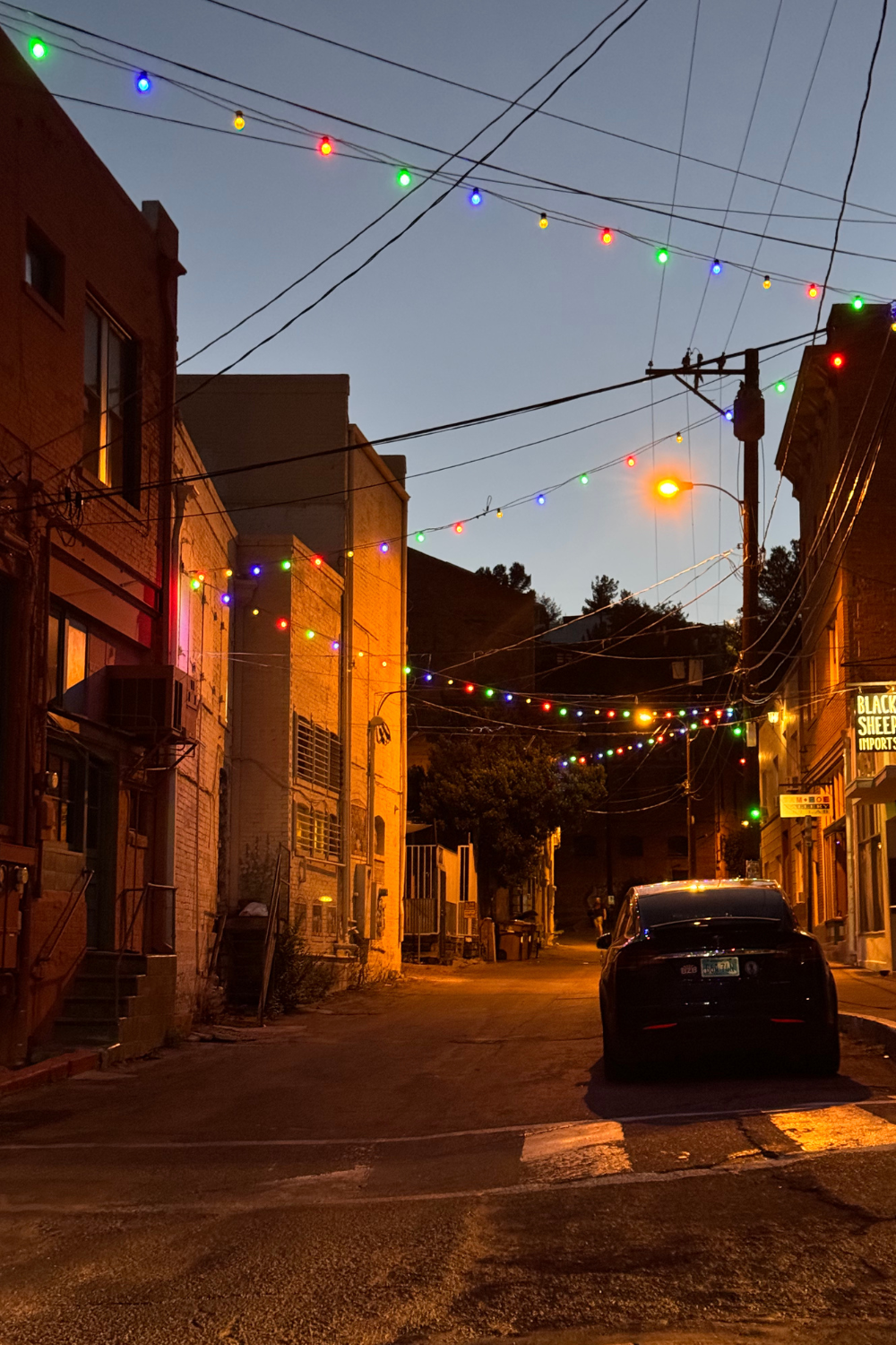 photo of a city at night with lights connecting buildings