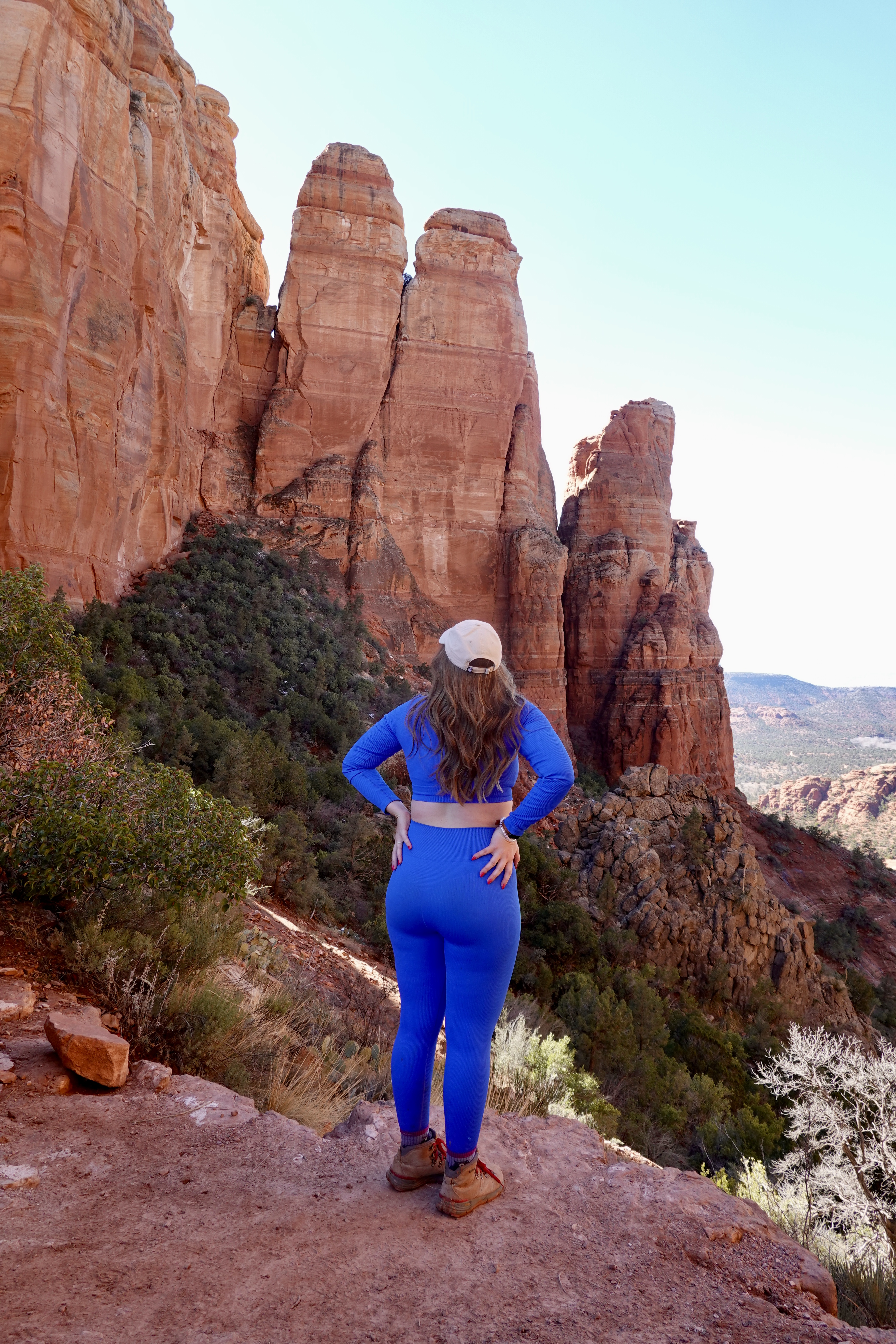 girl in a blue outfit in front of the red rock in sedona