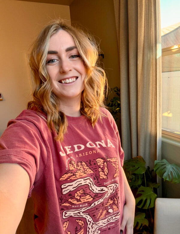 girl wearing a redish shirt with sedona designs on it