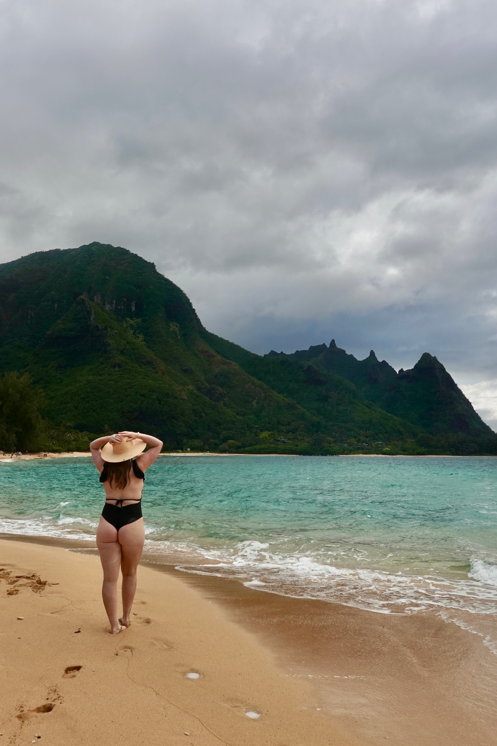 tunnels beach girl in a bikini and a wide hat at a beach