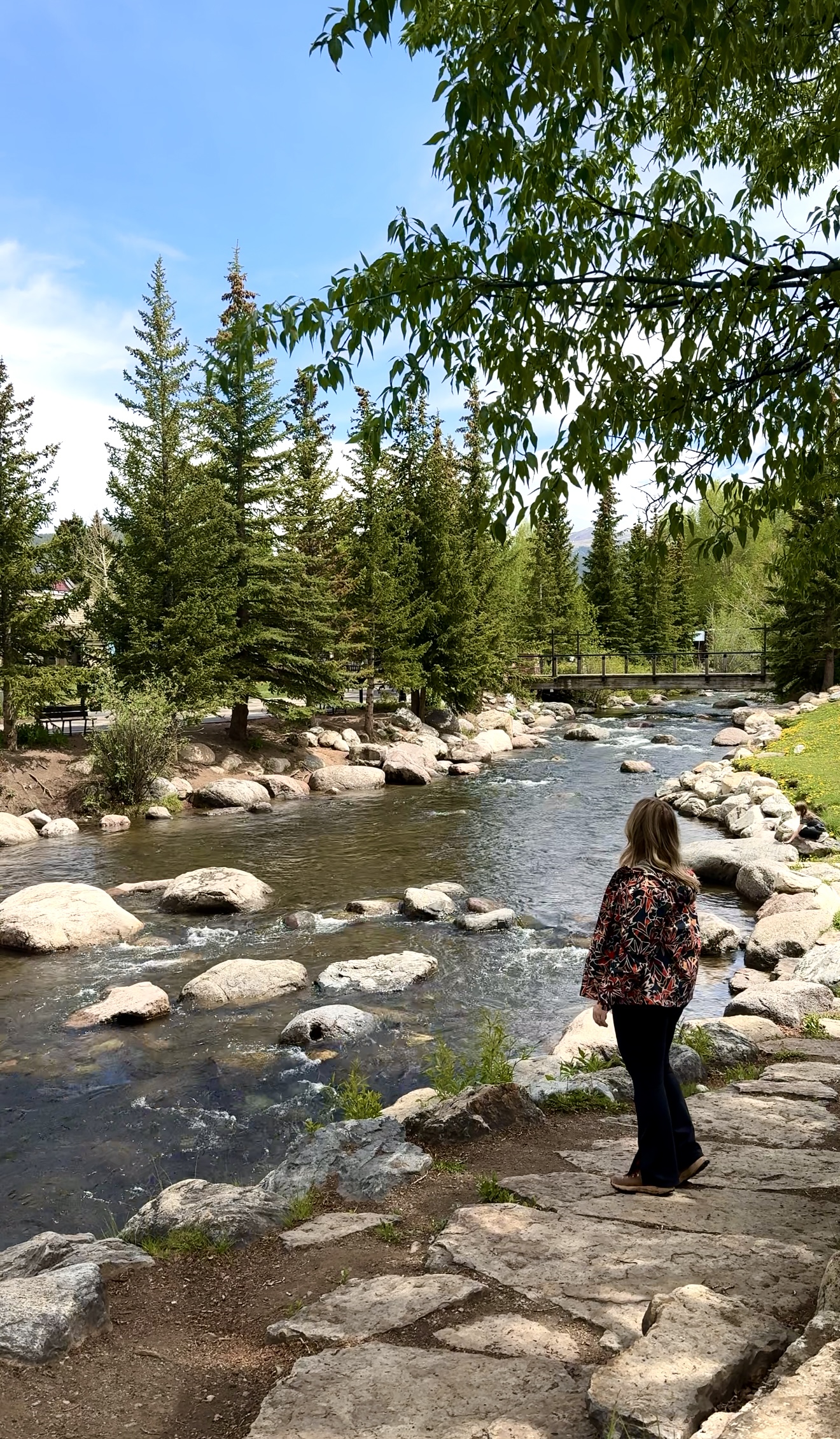 girl standing along the river in downtown breckenridge