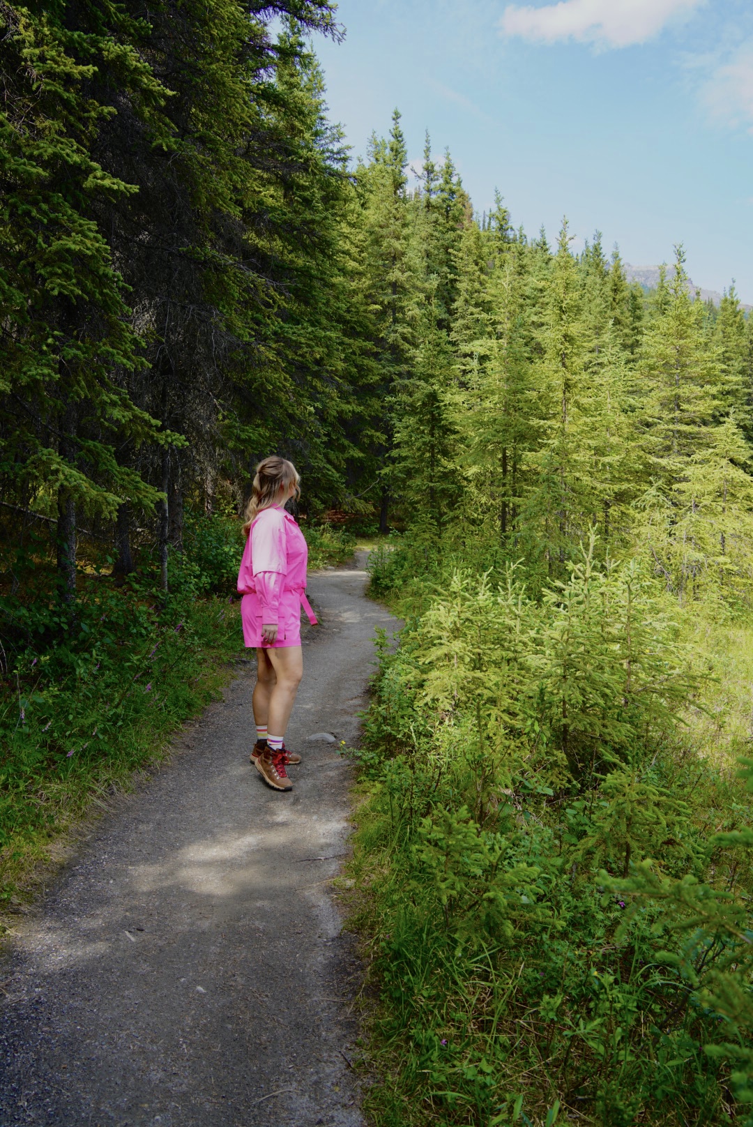 photo of a girl in pink on a trail in alaska