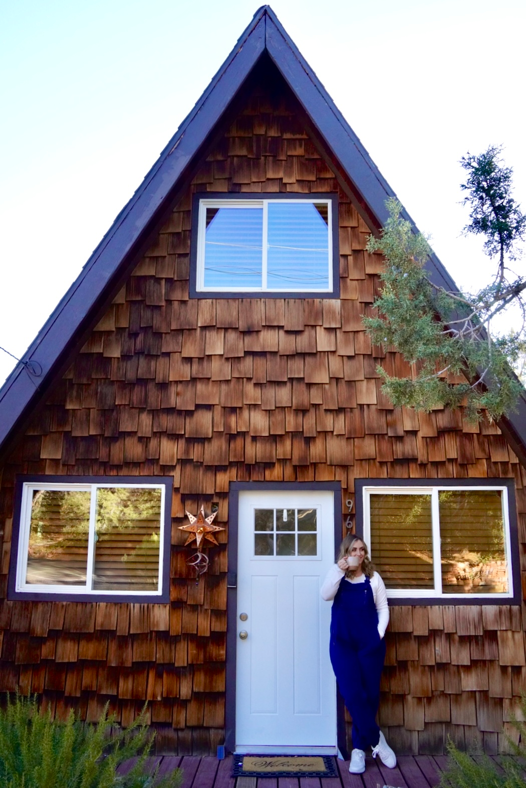 girl sipping coffee outside an a frame in sedona
