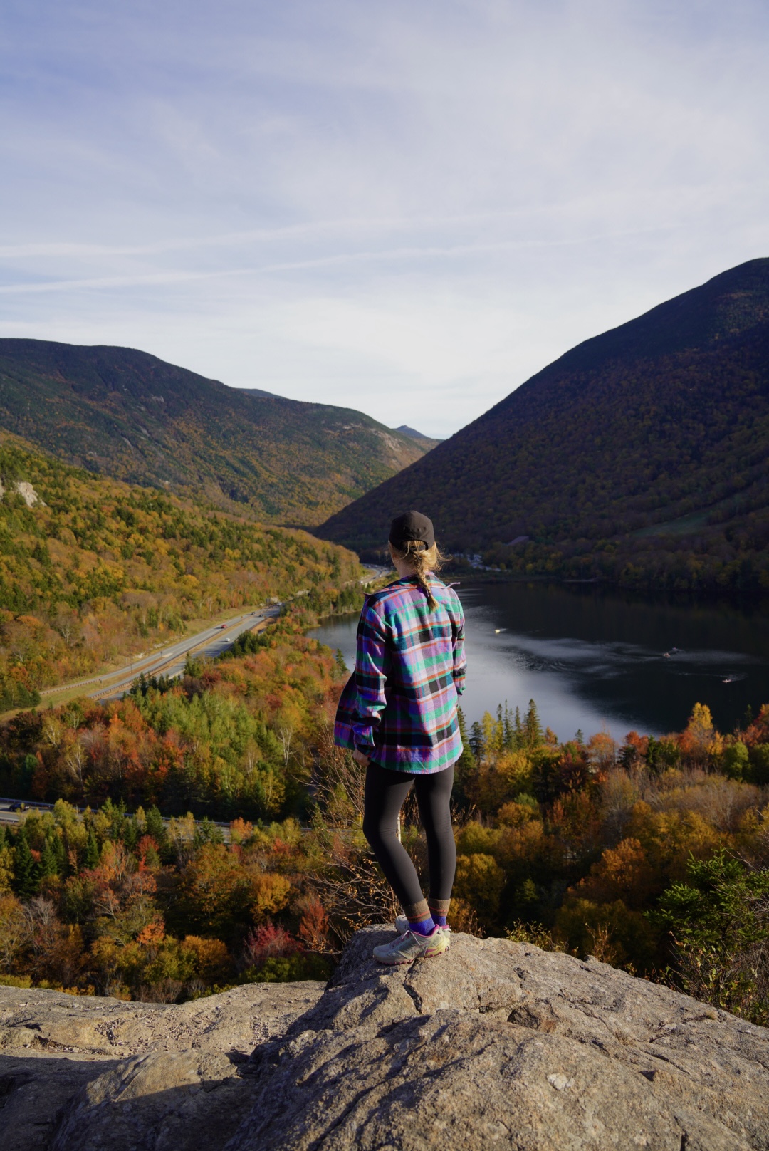 girl wearing a colorful flannel in the fall on a mountain