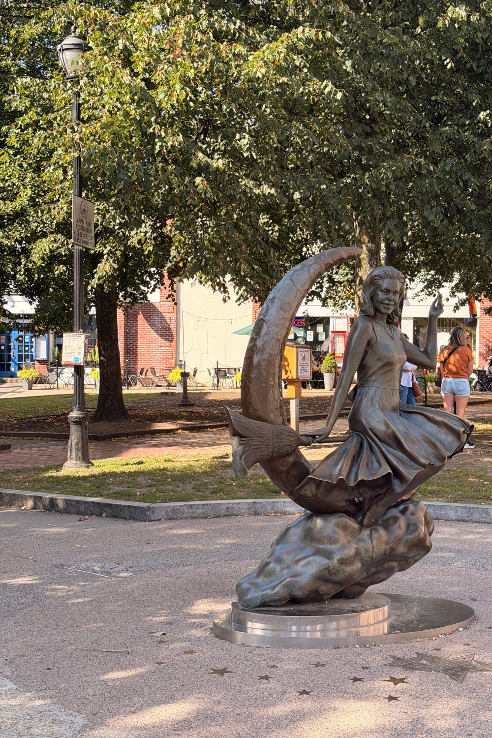photo of a statue of a witch on a moon in salem massachusetts