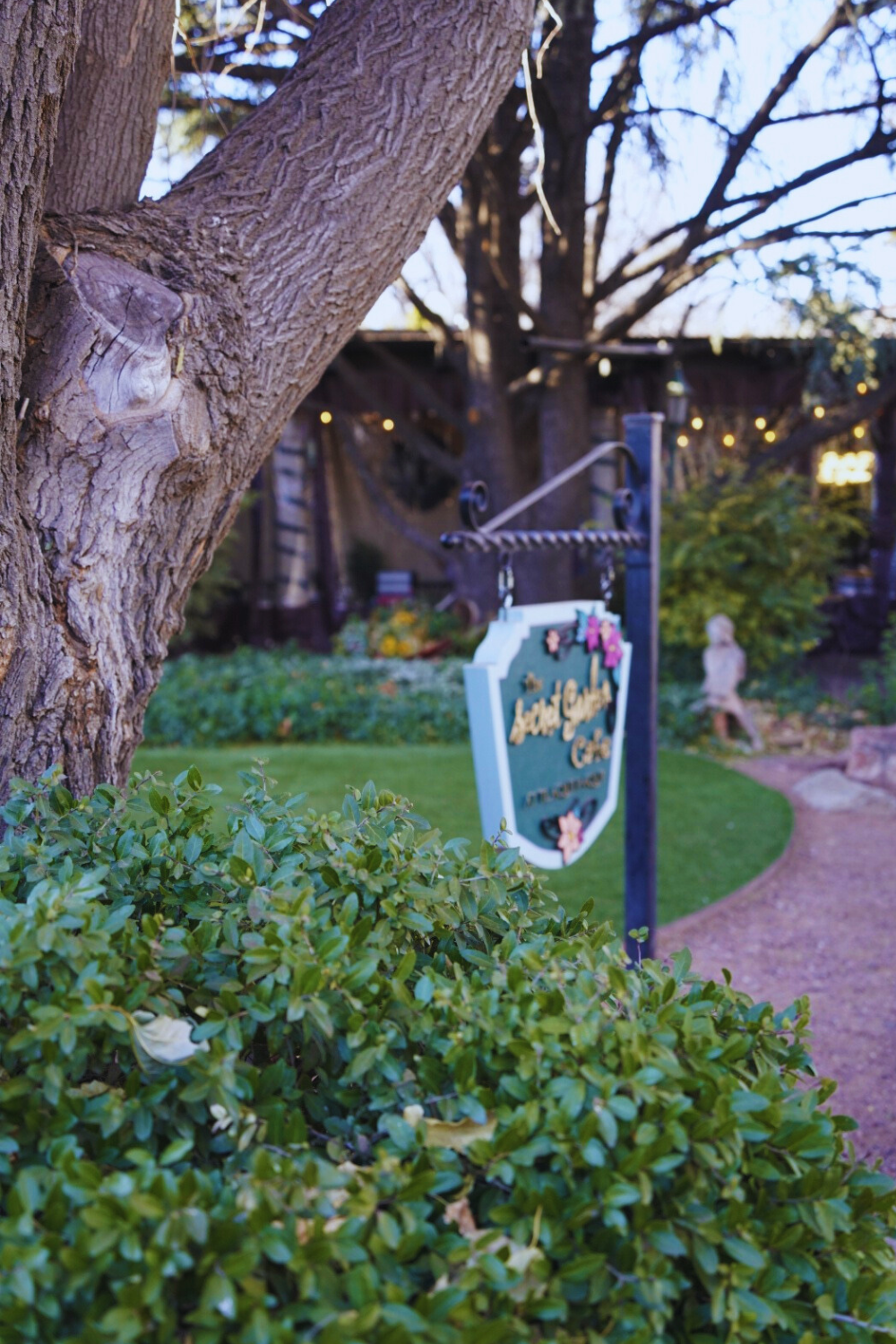 photo of a garden with a sign reading secret garden cafe, in sedona
