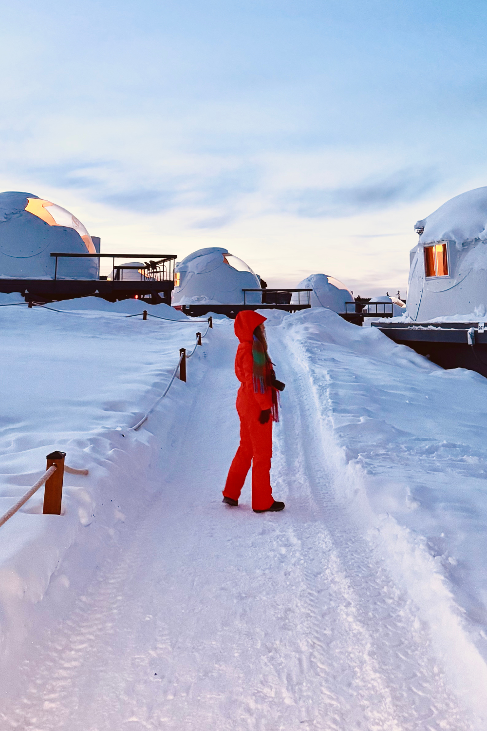 girl in an orange snowsuit at borealis basecamp at fairbanks alaska