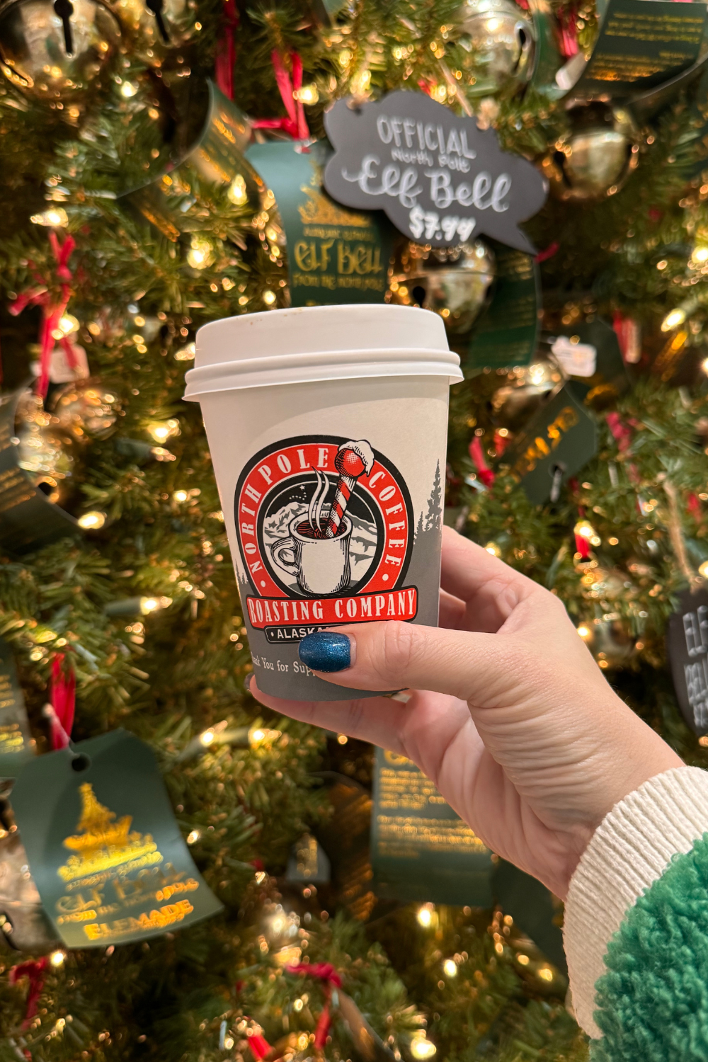 photo of a cup of coffee in front of a christmas tree