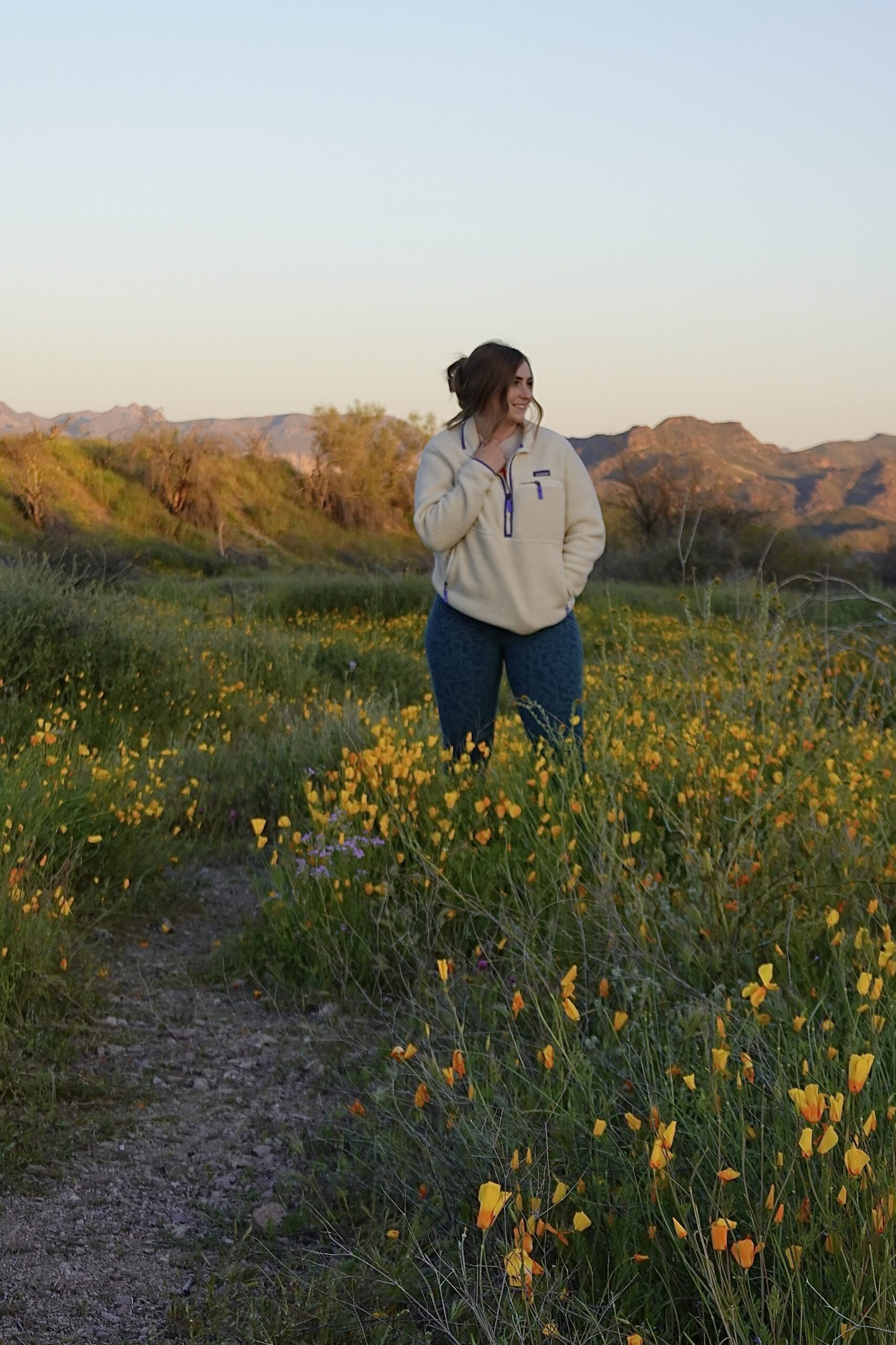 girl standing around wildflowers in arizona
