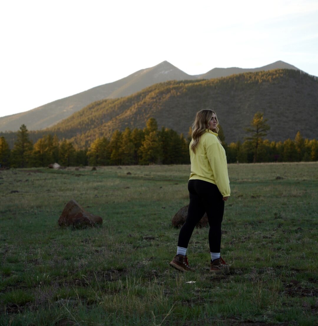 a girl in yellow fleece in flagstaff at sunset