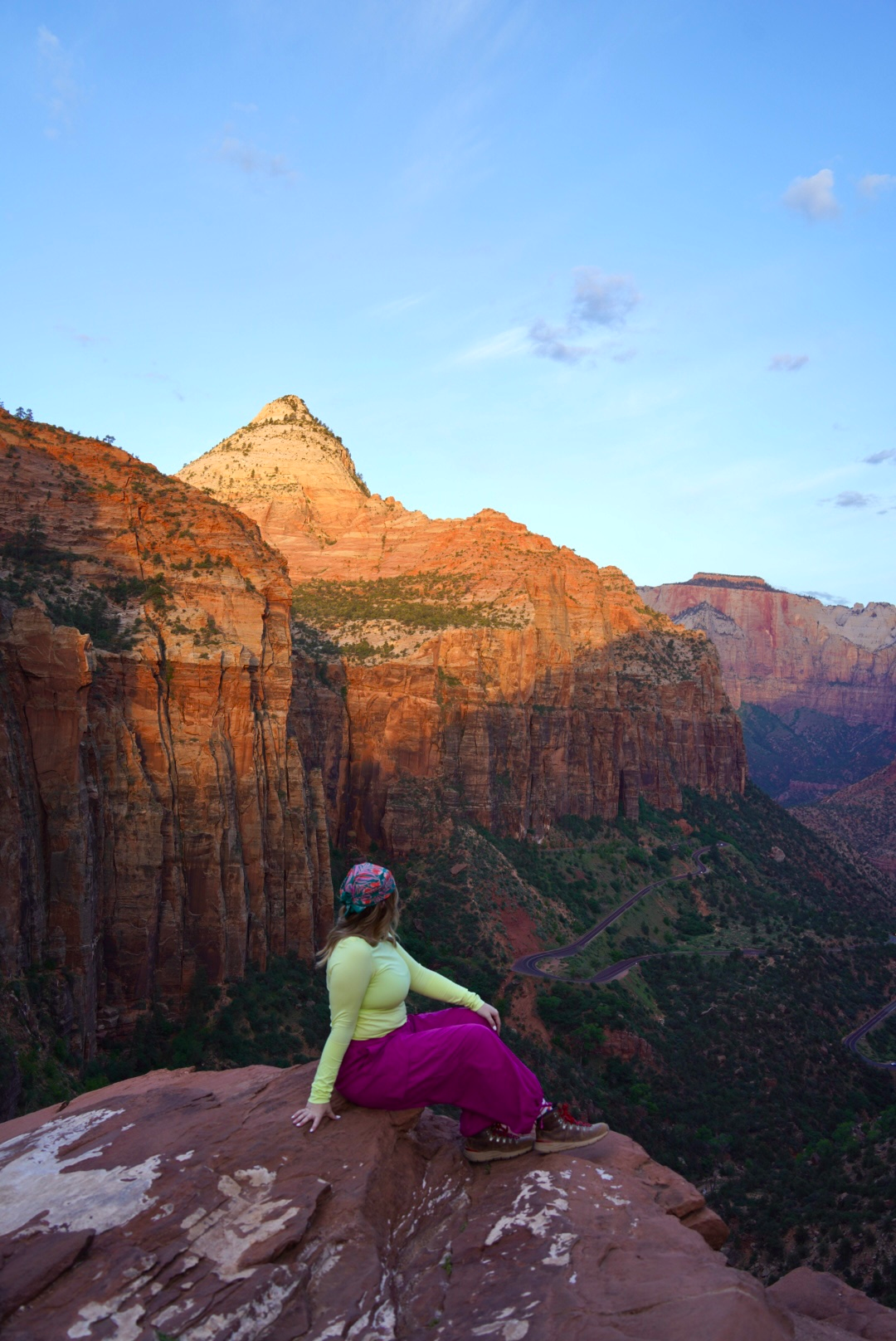 photo of a girl in a colorful outfit with an overlook of zion