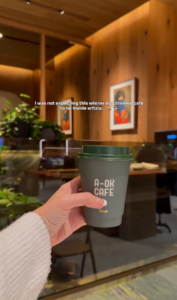 Coffee from A-OK Café inside the Aritzia store in Scottsdale, Arizona, with the modern café interior in the background.