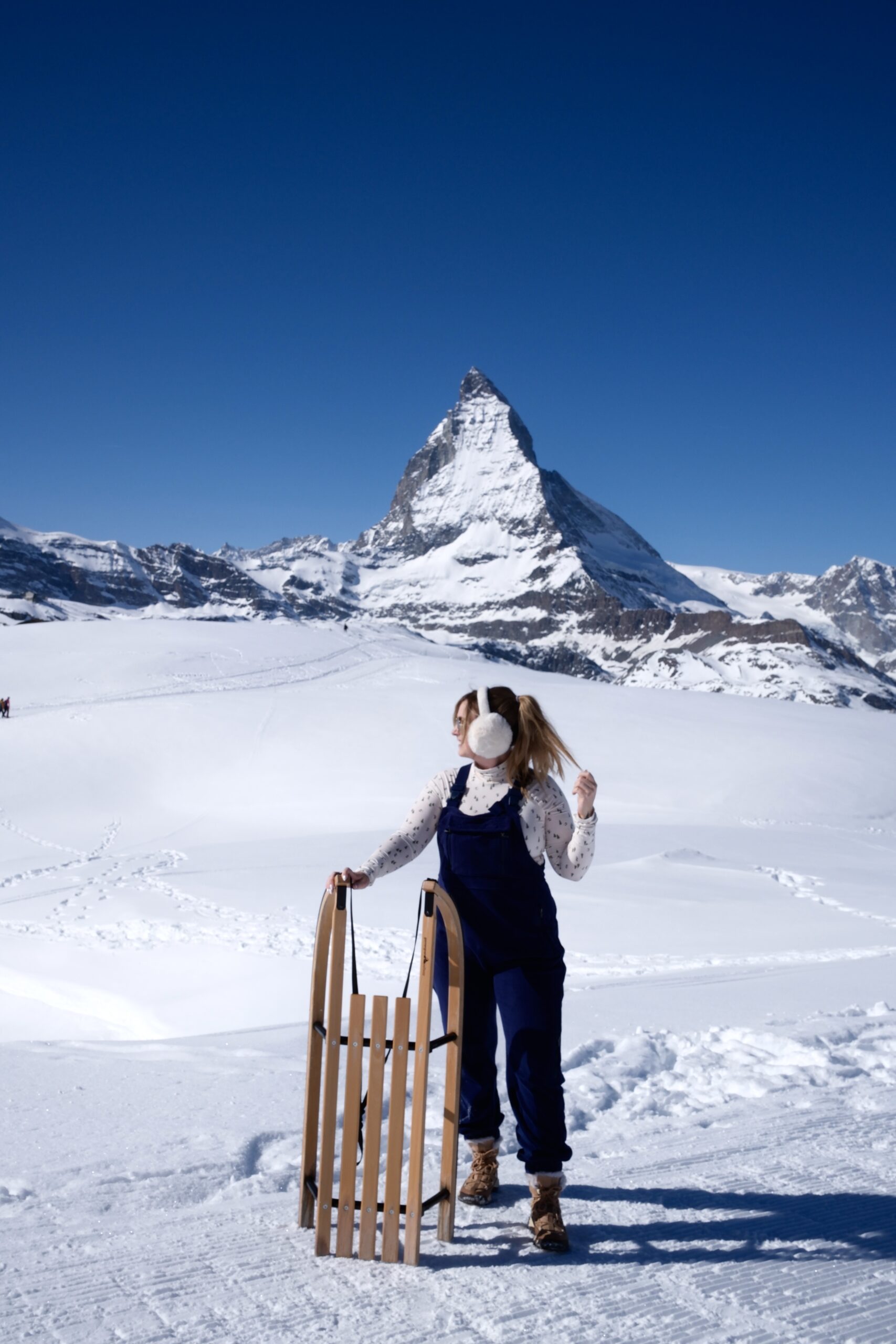 girl holding a vintage sled in Switzerland
