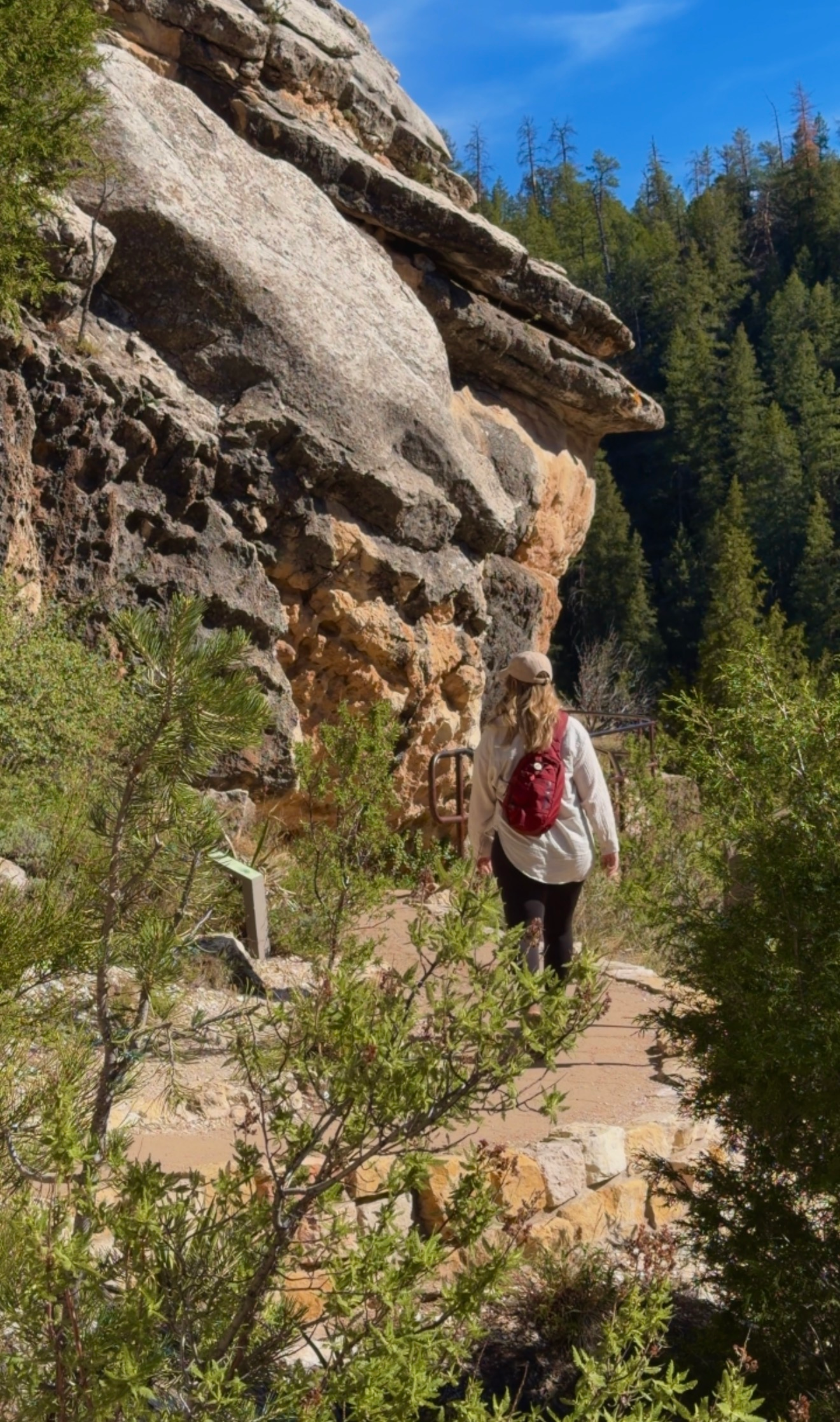 Woman hiking along the Island Trail at Walnut Canyon National Monument near Flagstaff, Arizona.