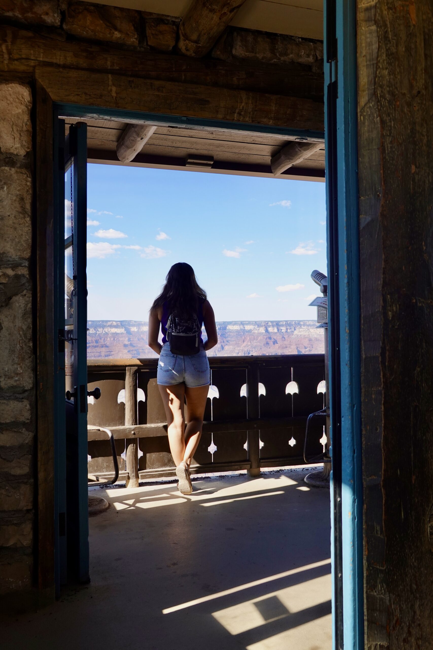 girl standing at a lookout of the grand canyon